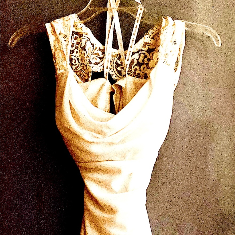 Wedding dress by ab/studios an off-white in color.